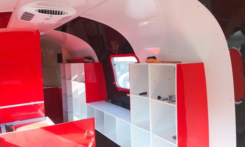 Intérieur d'une caravane aménagée rouge blanc noir